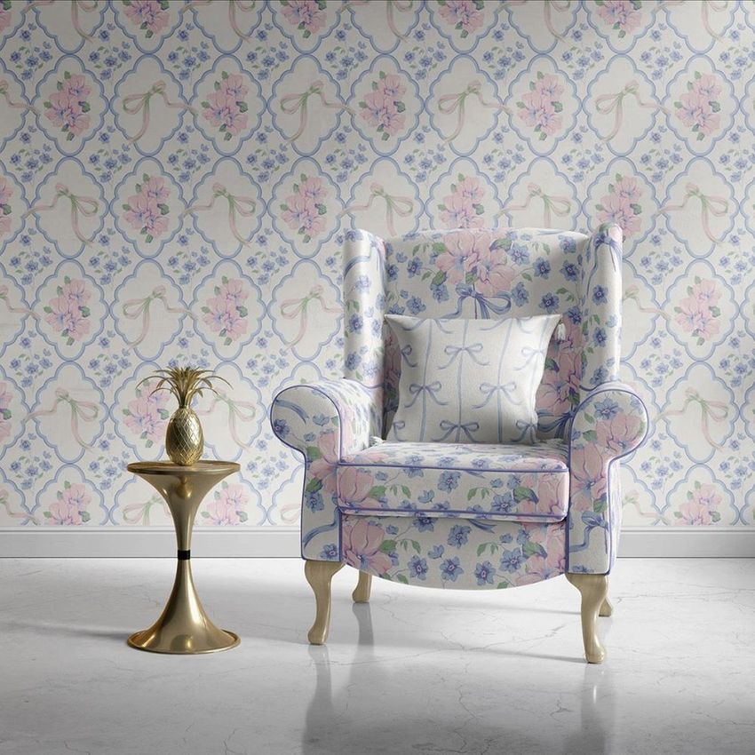 Retro velvet armchair mockup scene featuring a floral-patterned chair and pillow set against a pastel wallpaper background.