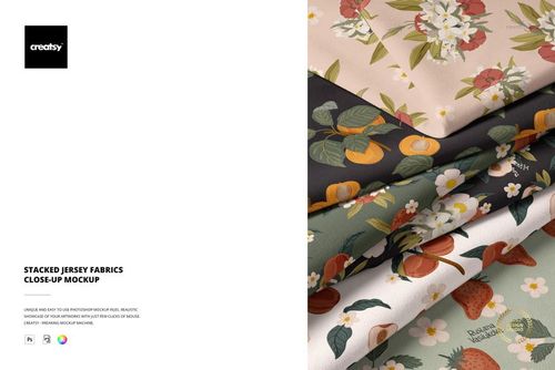 Close-up view of layered jersey fabric mockup with botanical and fruit designs in soft, natural tones.