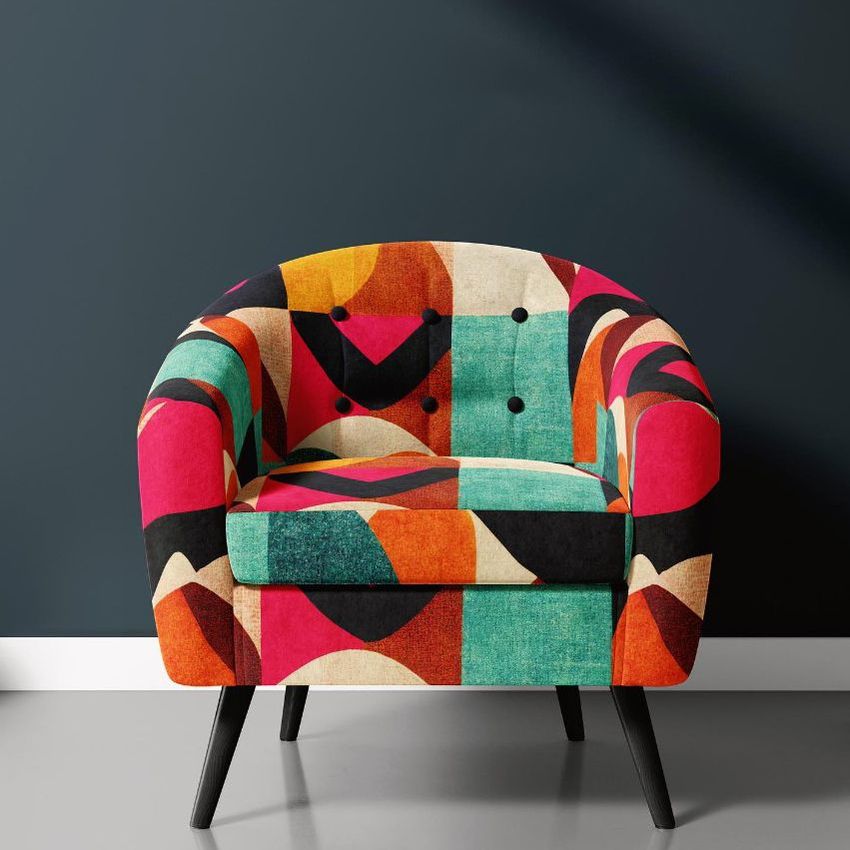 Interior scene mockup featuring a modern armchair with a bold, abstract pattern in red, teal, orange, and black tones.