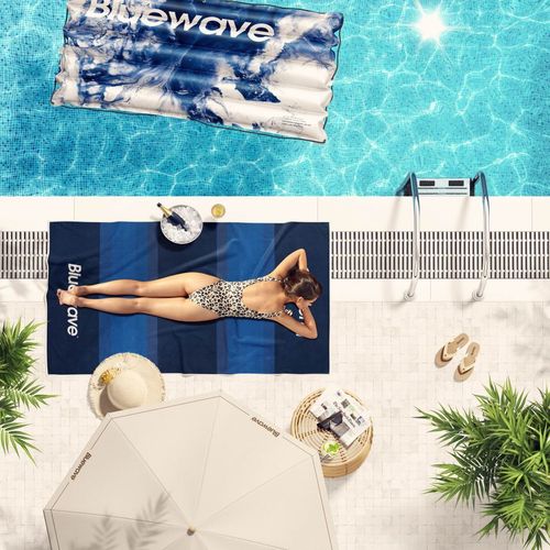 PSD mockup showing a poolside recreation area with a woman sunbathing on a towel and another towel in the pool.