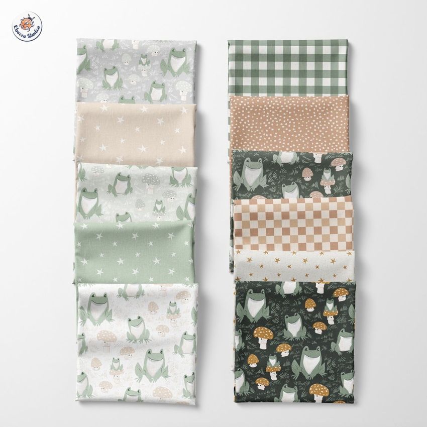 Folded fabrics mockup displaying ten fabric pieces with various patterns, including frogs, stars, mushrooms, checks, and polka dots.
