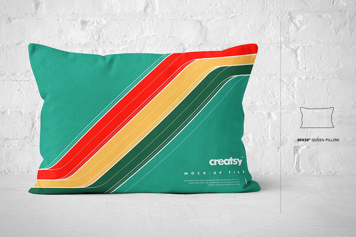 Queen size pillow mockup featuring bold diagonal stripes in red, yellow, and green, displayed on a white brick wall.