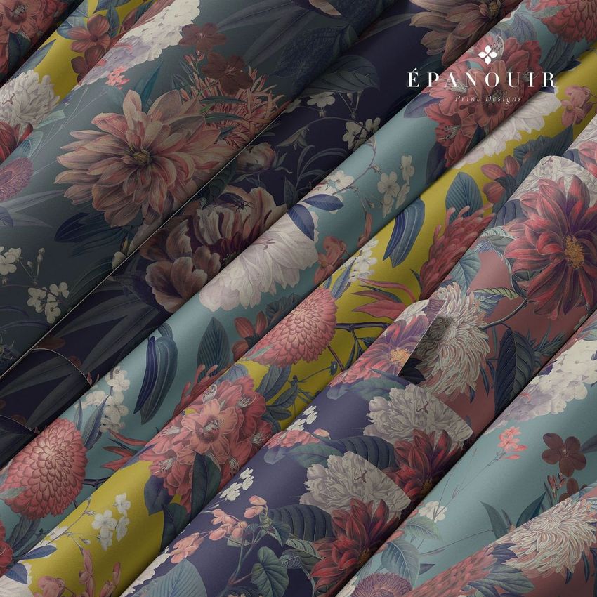 Paper wallpaper mockup featuring several rolled sheets with large floral patterns in shades of pink, green, blue, and yellow.