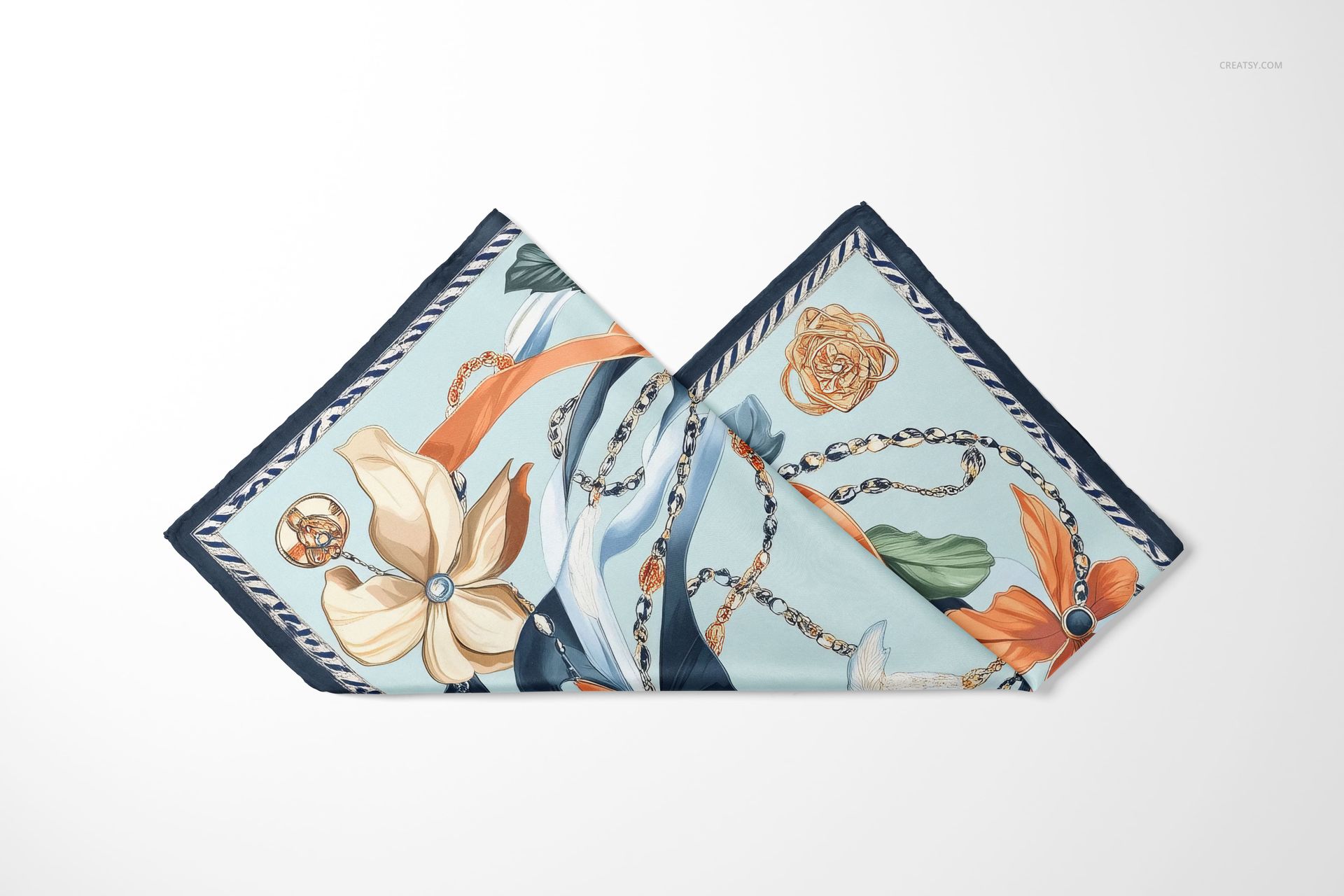 Folded silk scarf mockup featuring a mix of floral and chain motifs in blue, orange, and cream colors.