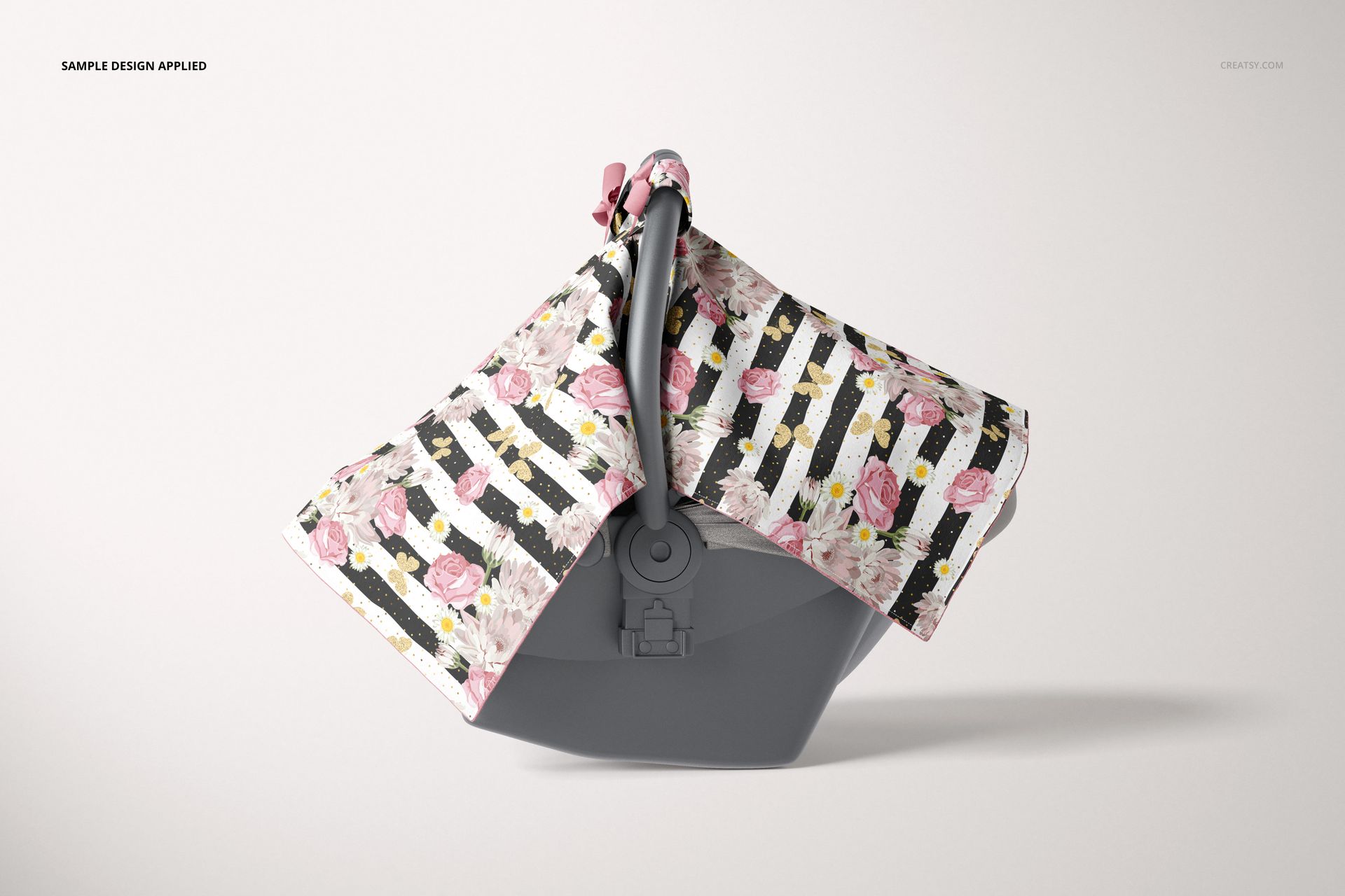 Mockup of a baby car seat canopy with pink flowers and stripes, displayed on a gray infant car seat, neutral background.