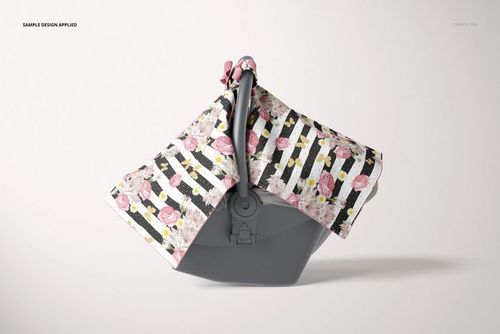 Mockup of a baby car seat canopy with pink flowers and stripes, displayed on a gray infant car seat, neutral background.
