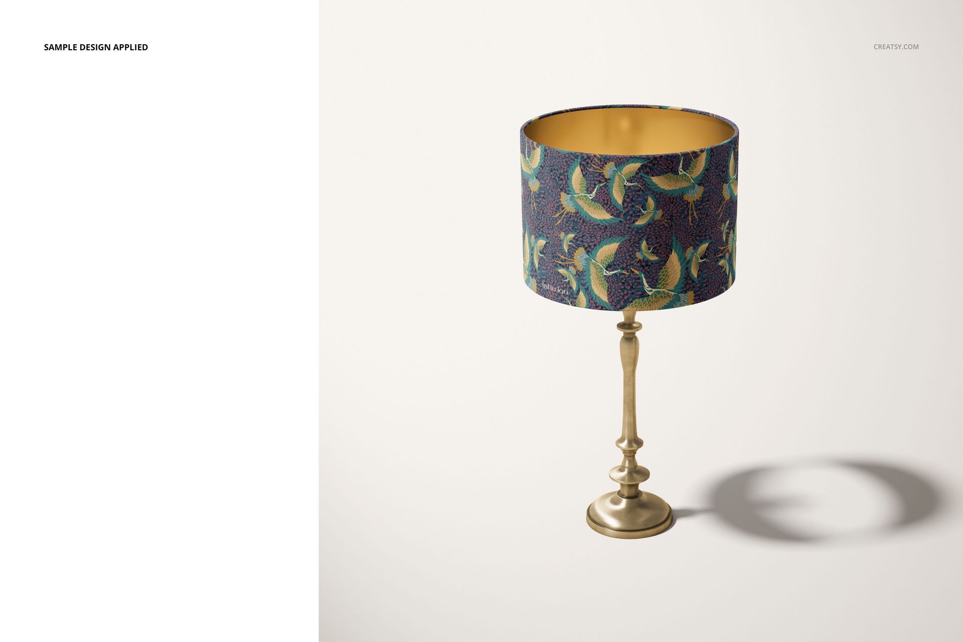 Front view of a mockup drum lamp shade featuring a blue background with green and yellow bird motifs on a metallic stand.