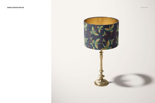 Front view of a mockup drum lamp shade featuring a blue background with green and yellow bird motifs on a metallic stand.