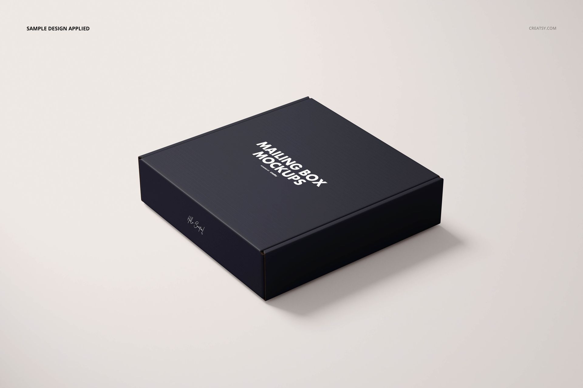 Mailing box mockup featuring a matte black finish and centered white lettering, displayed at an angle on a pale background.