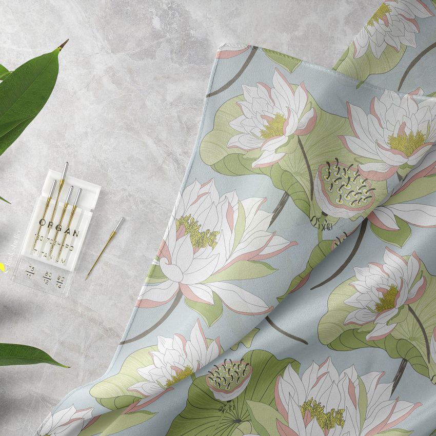 Silk scarf mockup featuring a closeup view of a fabric with a pastel lotus flower pattern on a light background.