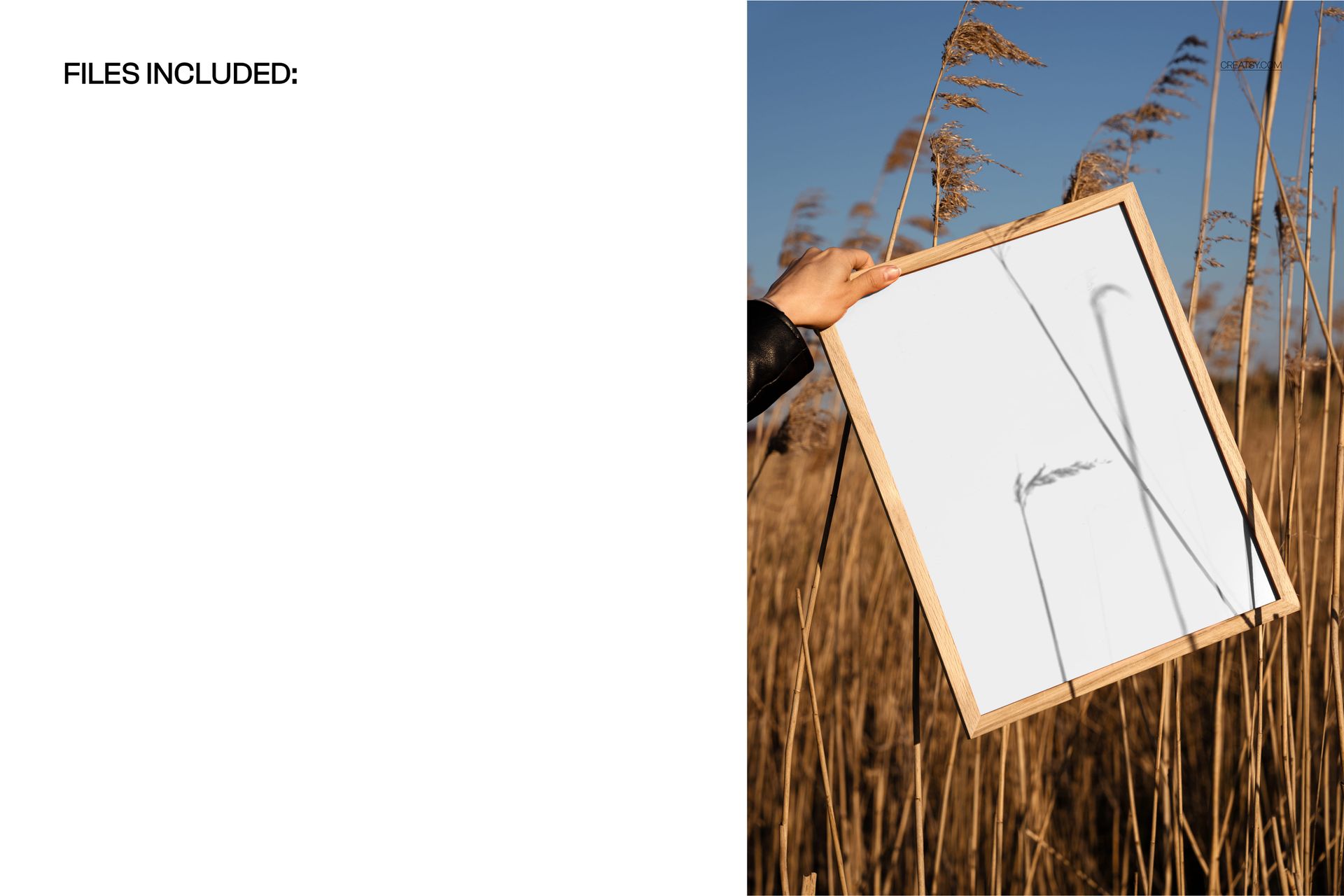 Wooden picture frame mockup held by hand among tall golden grass, with blue sky in the background.