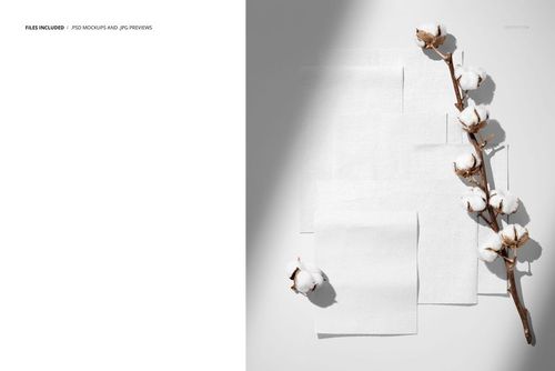 PSD mockup showing multiple cotton fabric swatches and a cotton branch, photographed from a top-down perspective.