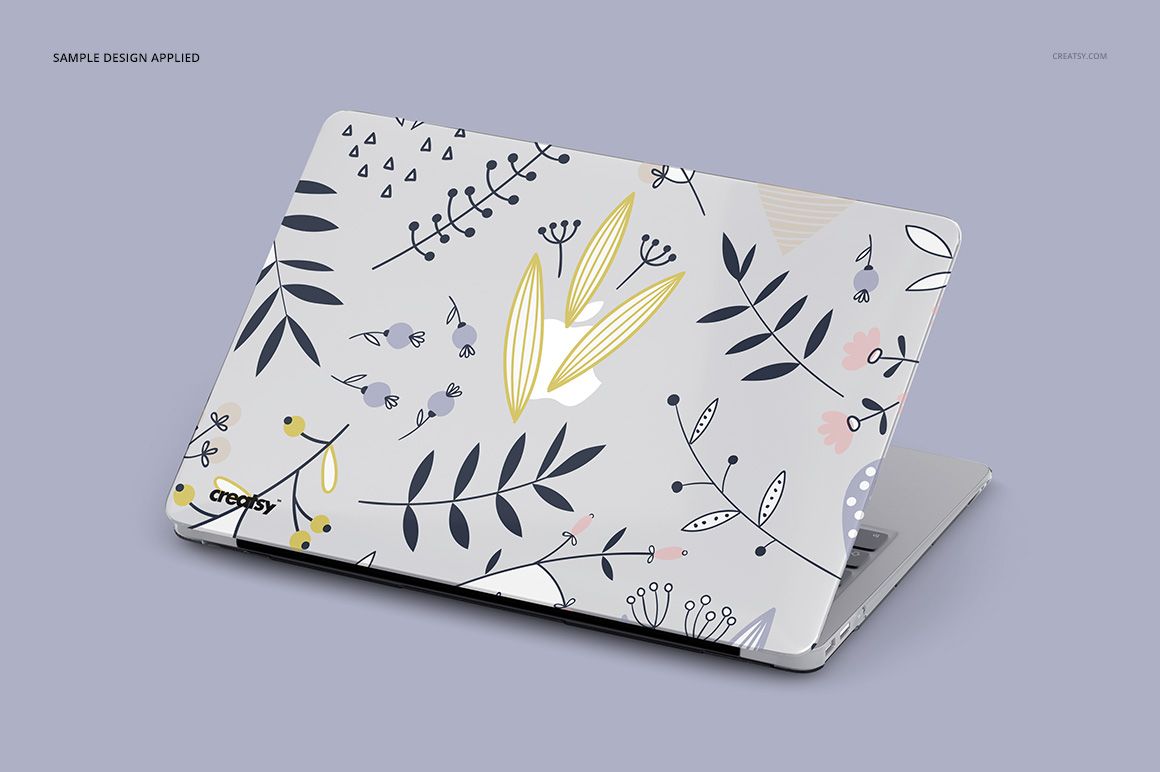 PSD mockup of a MacBook featuring a transparent case with floral and leaf designs, displayed in a three-quarter view.