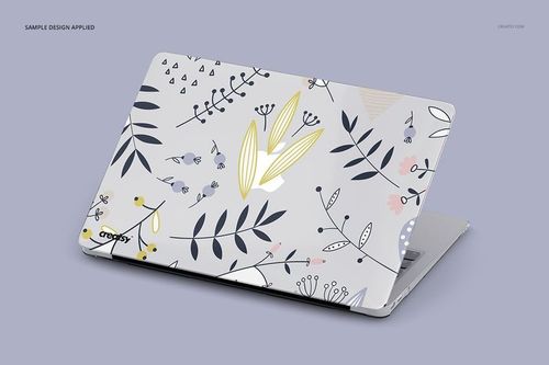 PSD mockup of a MacBook featuring a transparent case with floral and leaf designs, displayed in a three-quarter view.