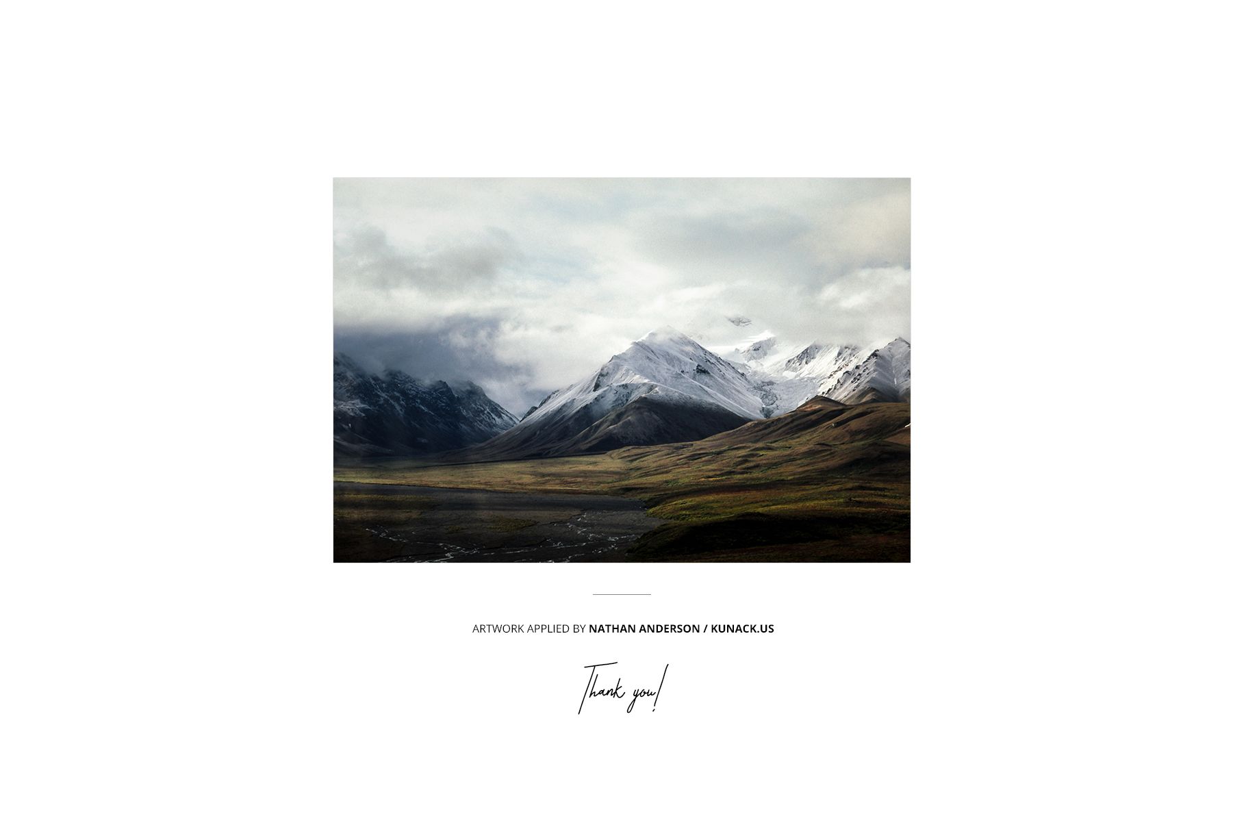 Mountain scene photo print mockup with dramatic clouds and green valleys, displayed on a plain white backdrop.