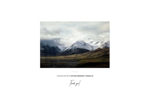 Mountain scene photo print mockup with dramatic clouds and green valleys, displayed on a plain white backdrop.