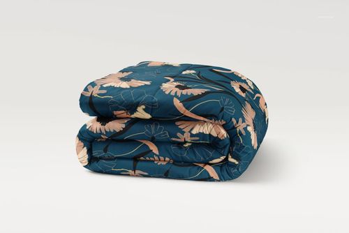 Microfiber comforter mockup featuring a folded design with soft pink and beige floral motifs on a navy base.