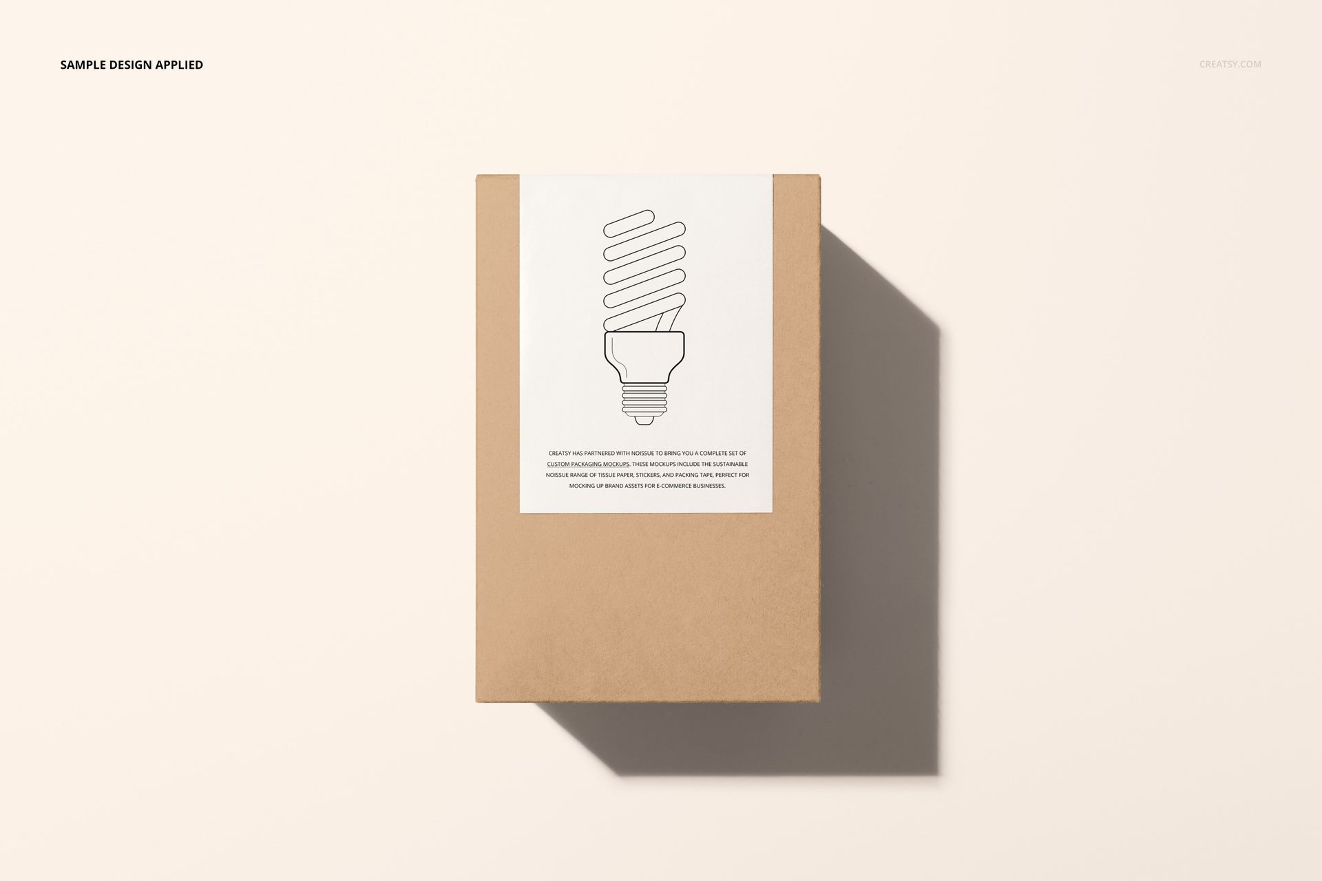 PSD mockup of a tall cardboard box with a white sticker and line art bulb design, presented in a flat lay perspective.