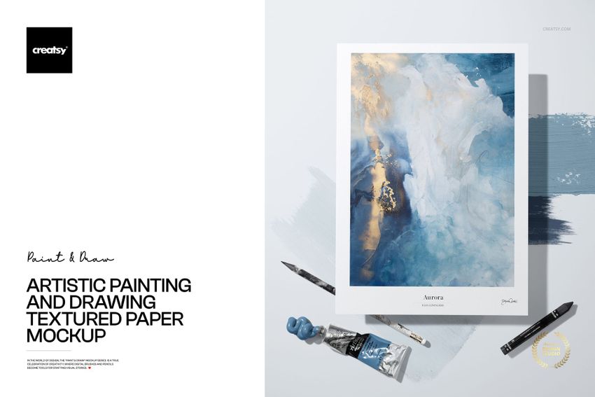 Textured paper mockup featuring an abstract painting in blue, white, and gold tones, shown from a top view with art supplies.