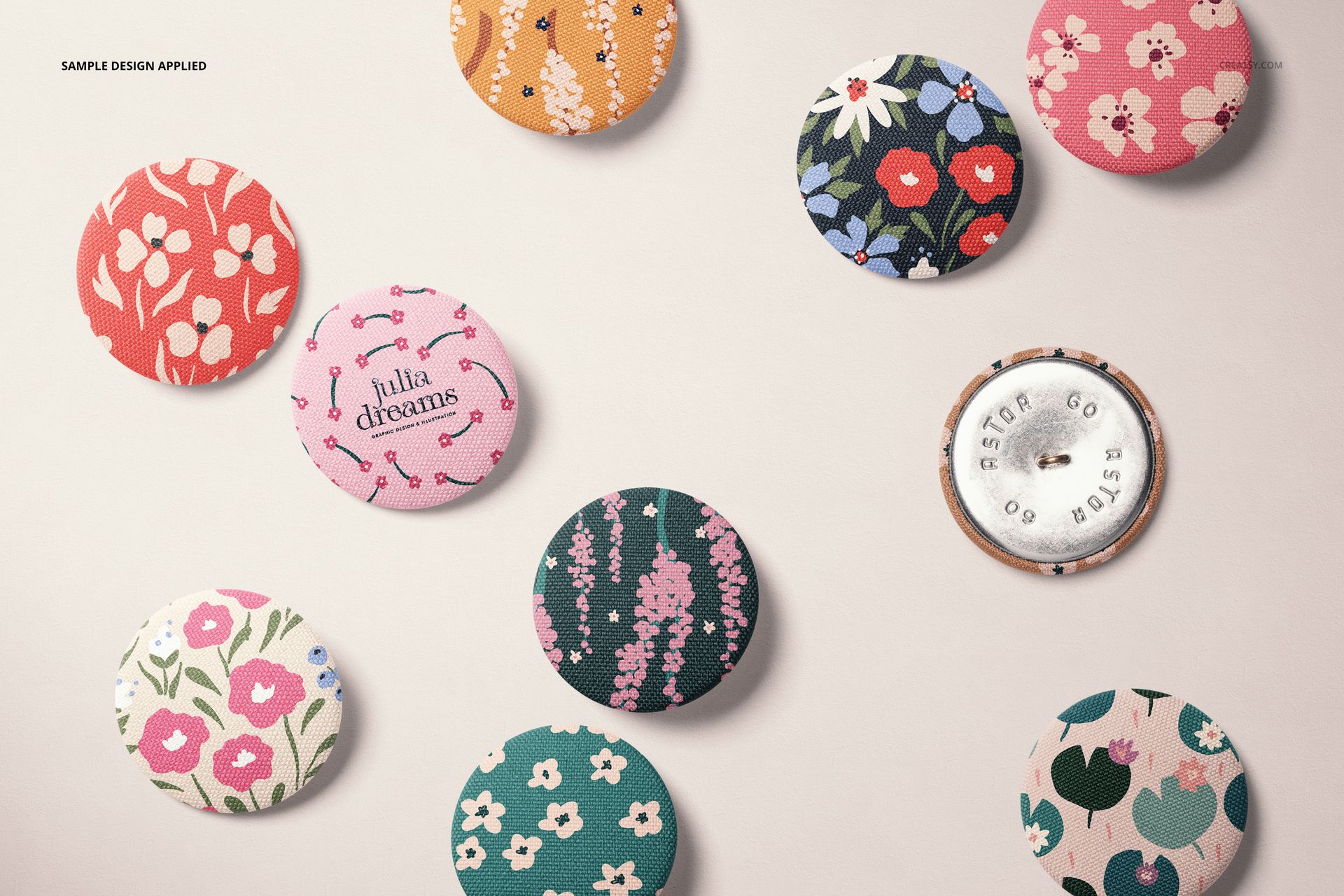 Fabric buttons with various colorful floral and heart patterns arranged on a light surface, top view mockup.