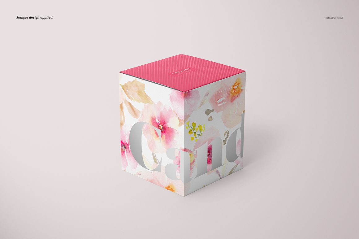 Mockup of a floral-patterned candle box with matte glass effect, pink top, and soft pastel colors, front perspective.