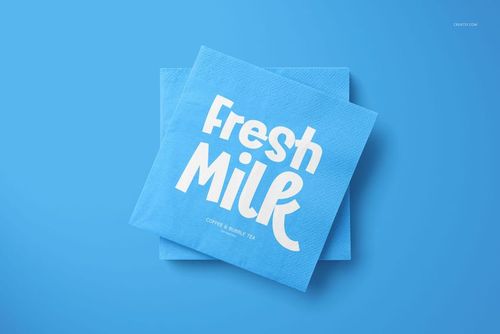 PSD mockup of two stacked blue napkins, one displaying white graphic text, set against a plain blue backdrop.