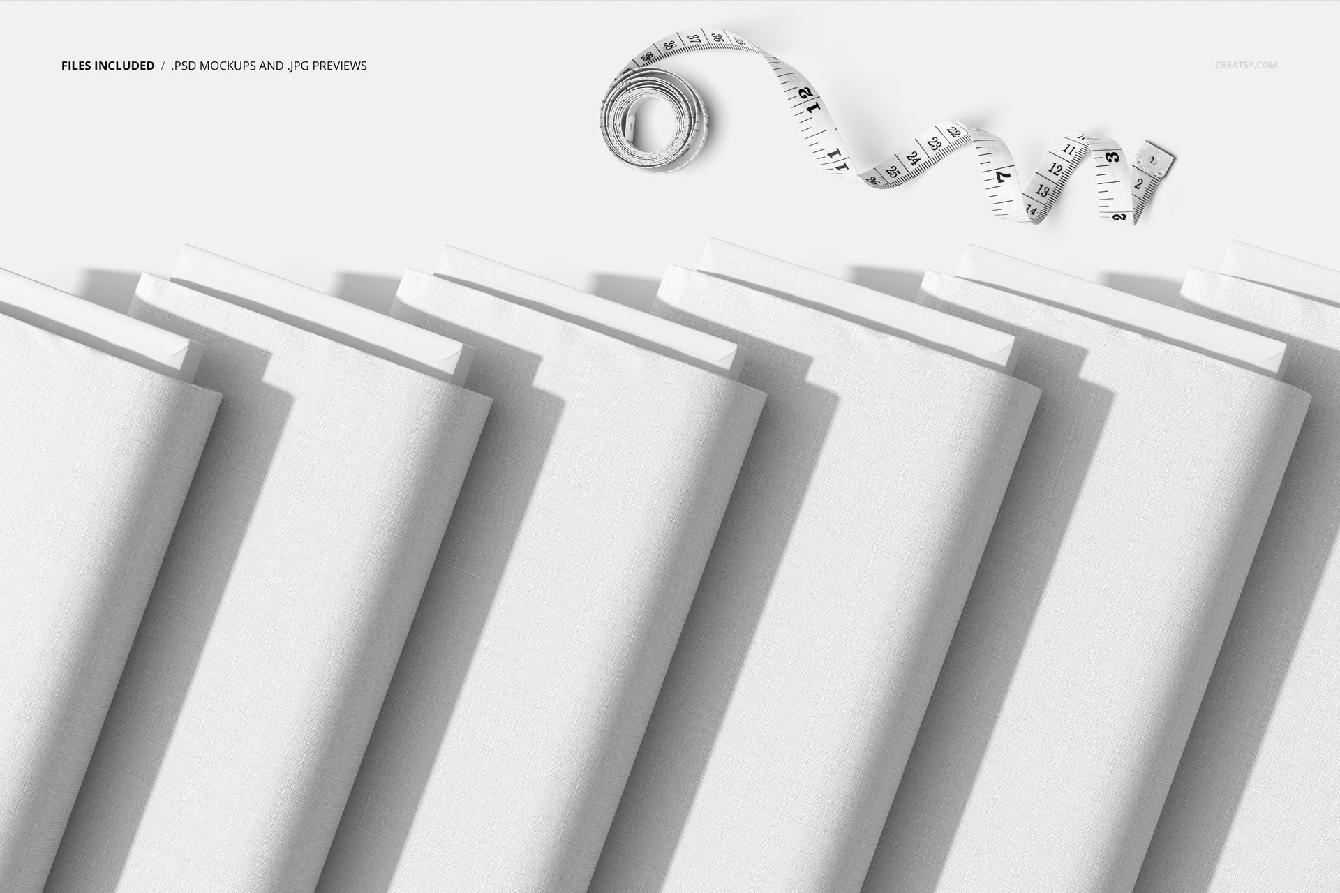 PSD mockup featuring multiple white fabric bolts lined up diagonally, accompanied by a coiled measuring tape.
