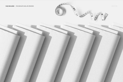 PSD mockup featuring multiple white fabric bolts lined up diagonally, accompanied by a coiled measuring tape.