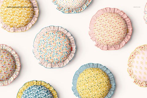 PSD mockup of decorative ruffled pillows in different pastel shades and small flower prints, seen from a top perspective.