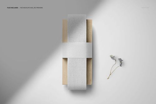Top view of a wide cotton ribbon mockup in pale gray, wrapped around a wooden box with dried flowers nearby.