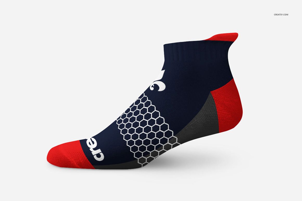 Athletic sock mockup featuring a low-cut design in navy blue with red accents and a honeycomb pattern, side view.