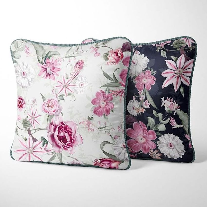Silk cushion mockup featuring two square pillows with braided edges, one with a white background and pink floral pattern, the other with a dark background and similar flowers.