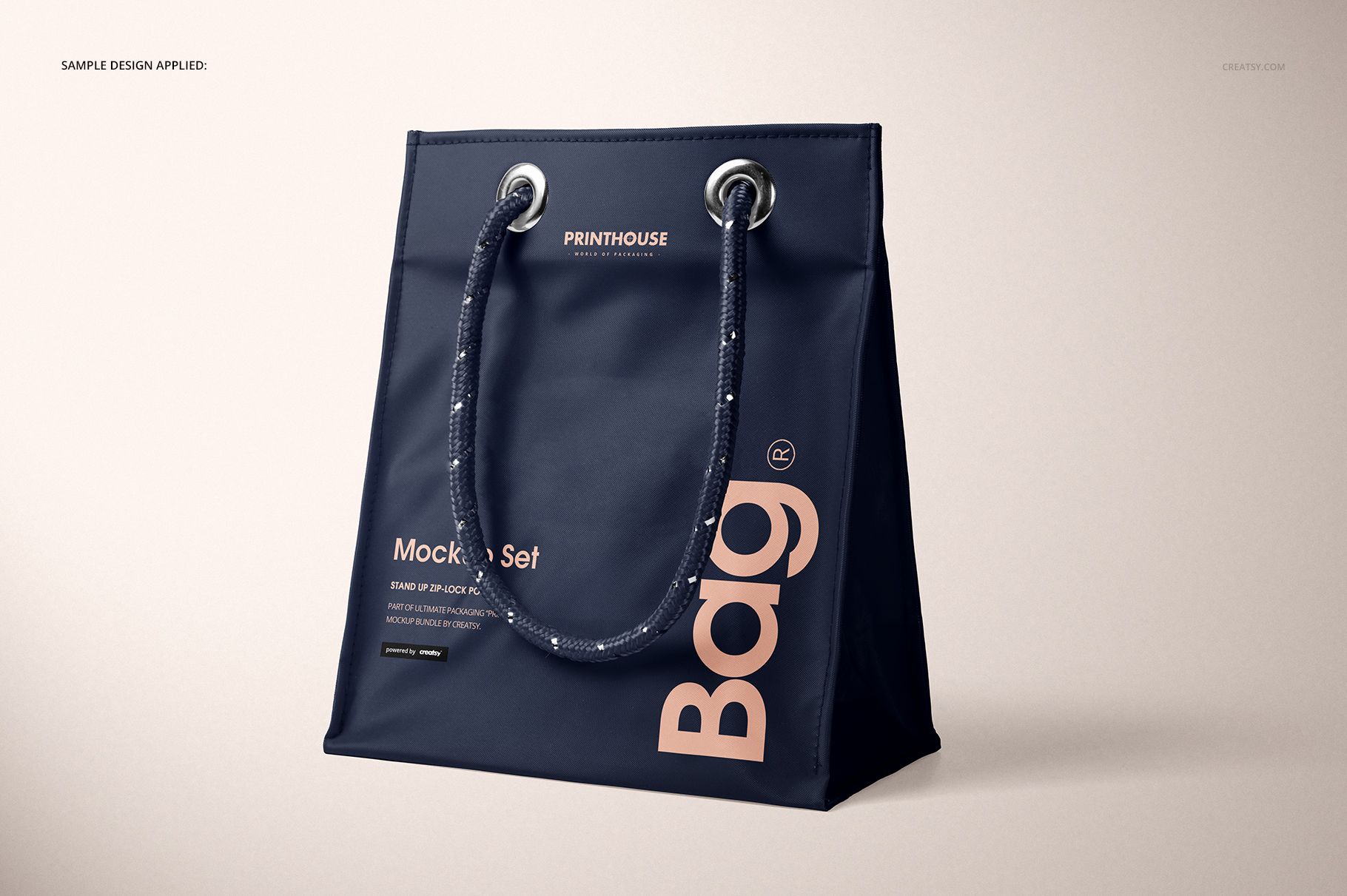 Matte PVC reusable tote bag mockup in dark blue with large beige text, shown at a three-quarter front angle on a neutral background.