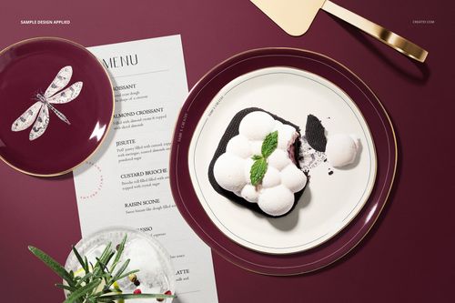Top view of a plate mockup set with burgundy and white plates, dessert, menu, and pastry shop props on a burgundy surface.
