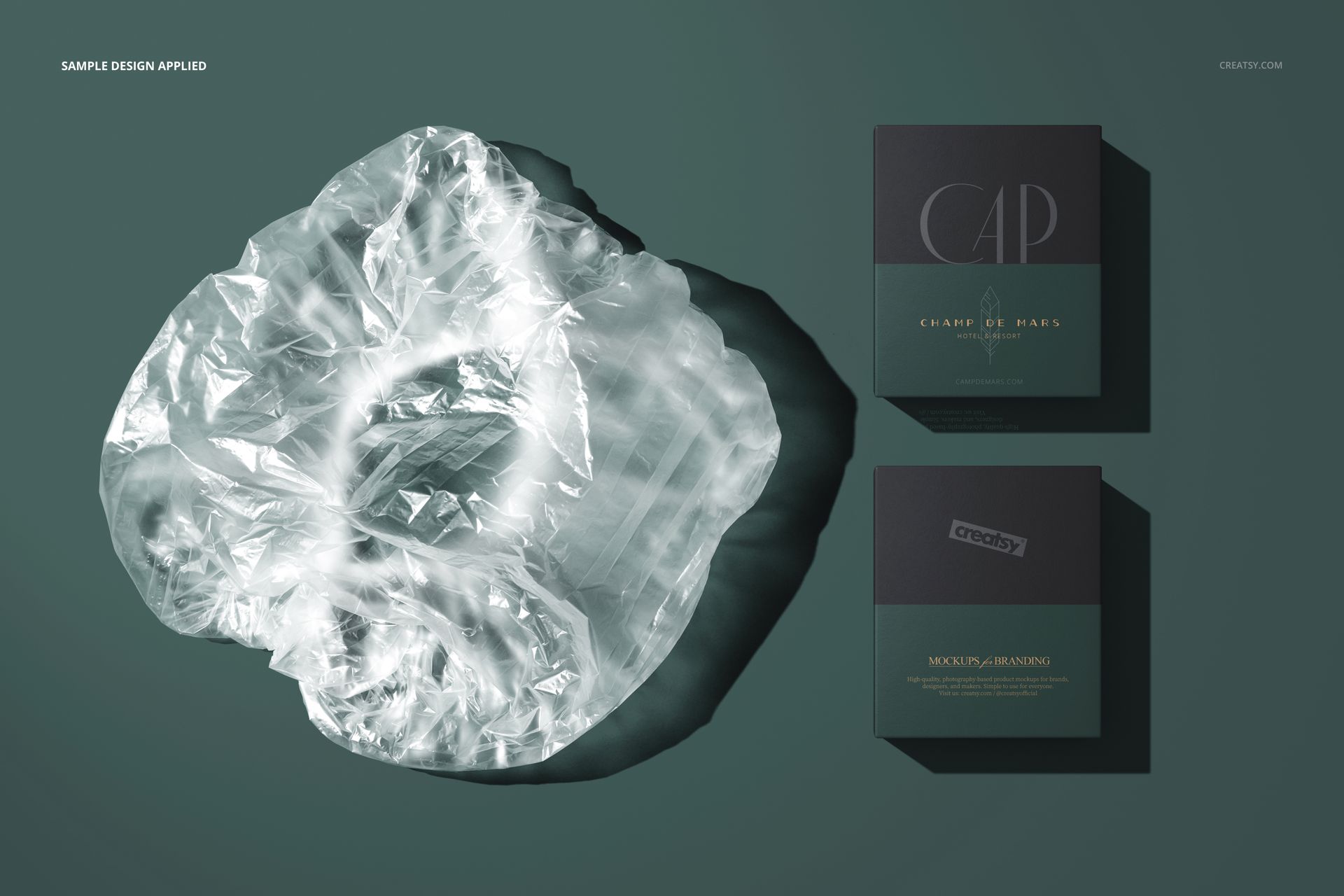 PSD mockup showing a transparent shower cap and two boxed packages arranged on a solid green background, viewed from above.