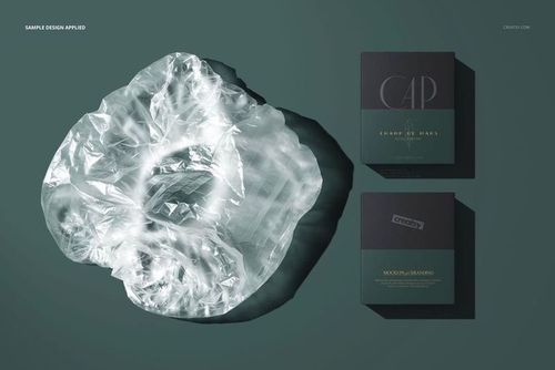 PSD mockup showing a transparent shower cap and two boxed packages arranged on a solid green background, viewed from above.