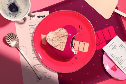 Valentine's Day PSD mockup featuring a heart-shaped pastry on a pink dish, with utensils and a coffee cup nearby.