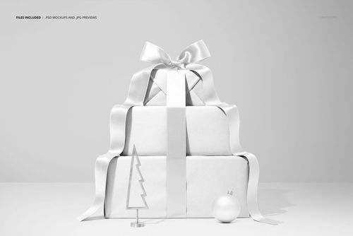 PSD mockup featuring a stack of holiday gift boxes tied with a large ribbon, next to a small tree ornament and round bauble.