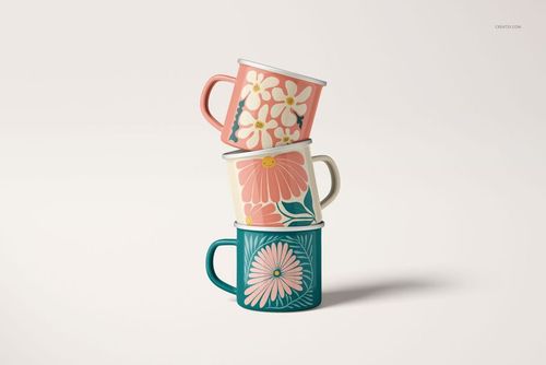 PSD mockup set showing enamel mugs with floral artwork, viewed from the front against a neutral backdrop.