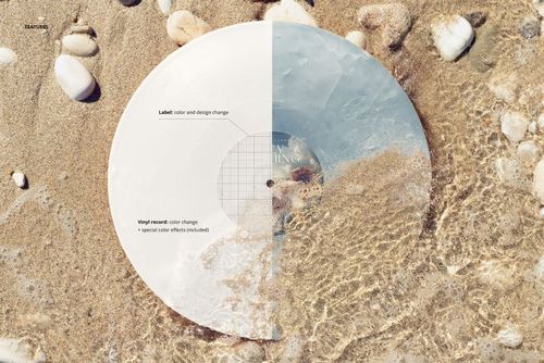 PSD mockup of a vinyl record placed on sand by the Adriatic Sea, half submerged in shallow water with visible stones.