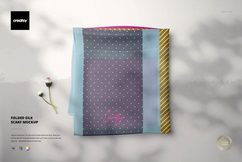 Folded silk scarf mockup featuring a rectangular scarf with polka dot and striped patterns, top view on a light surface.