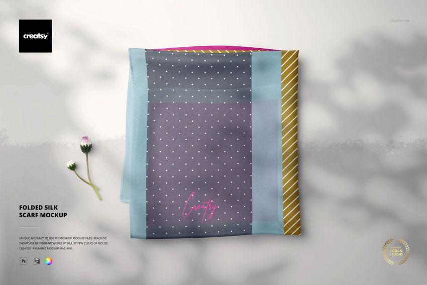Folded silk scarf mockup featuring a rectangular scarf with polka dot and striped patterns, top view on a light surface.
