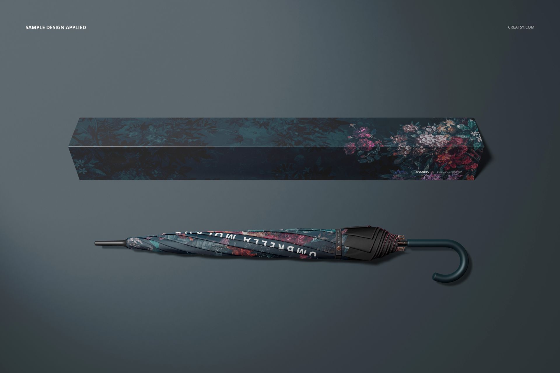 Umbrella mockup featuring a folded umbrella and coordinating box with dark floral design, displayed on gray background.