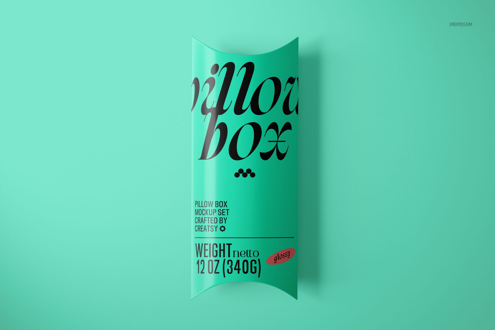 Turquoise pillow box mockup with large black lettering and weight information, displayed on a solid mint backdrop.