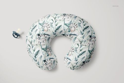 Nursing pillow mockup shown from above, featuring a leafy pattern and a pacifier on a neutral background.