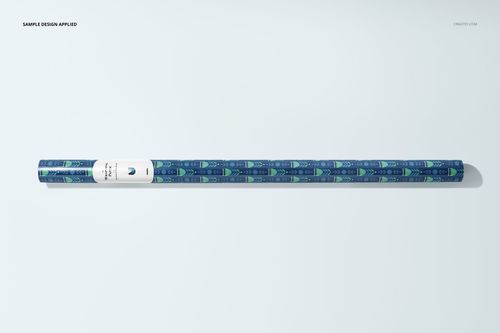Gift wrapping paper PSD mockup roll with a decorative blue and green motif, displayed from a bird’s-eye perspective.