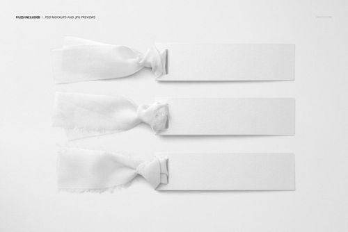 PSD mockup showing three horizontal silk ribbons secured to textured paper tags, viewed from above on a neutral backdrop.