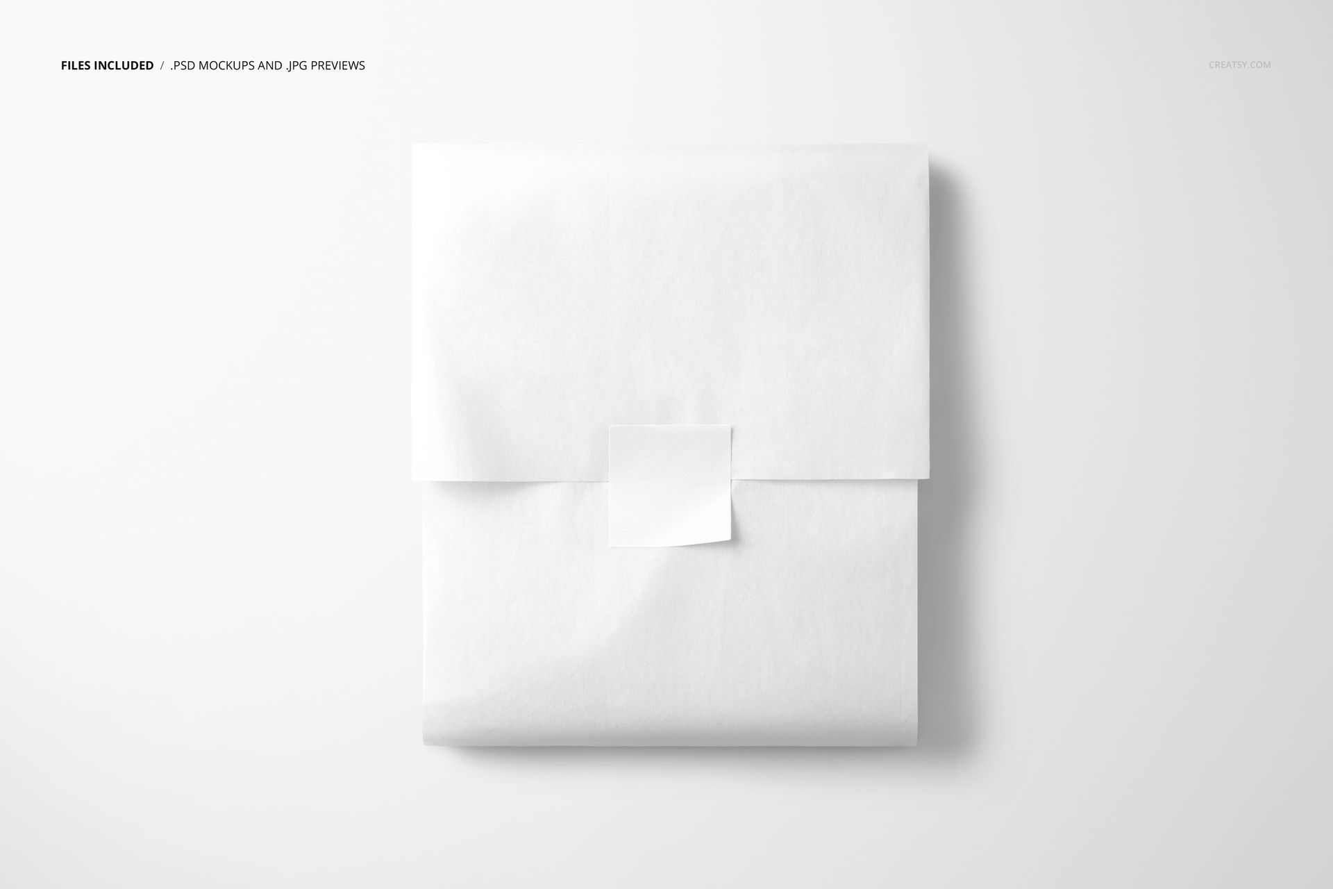 White tissue paper folded into a square shape and sealed with a square sticker, displayed flat in a PSD mockup scene.