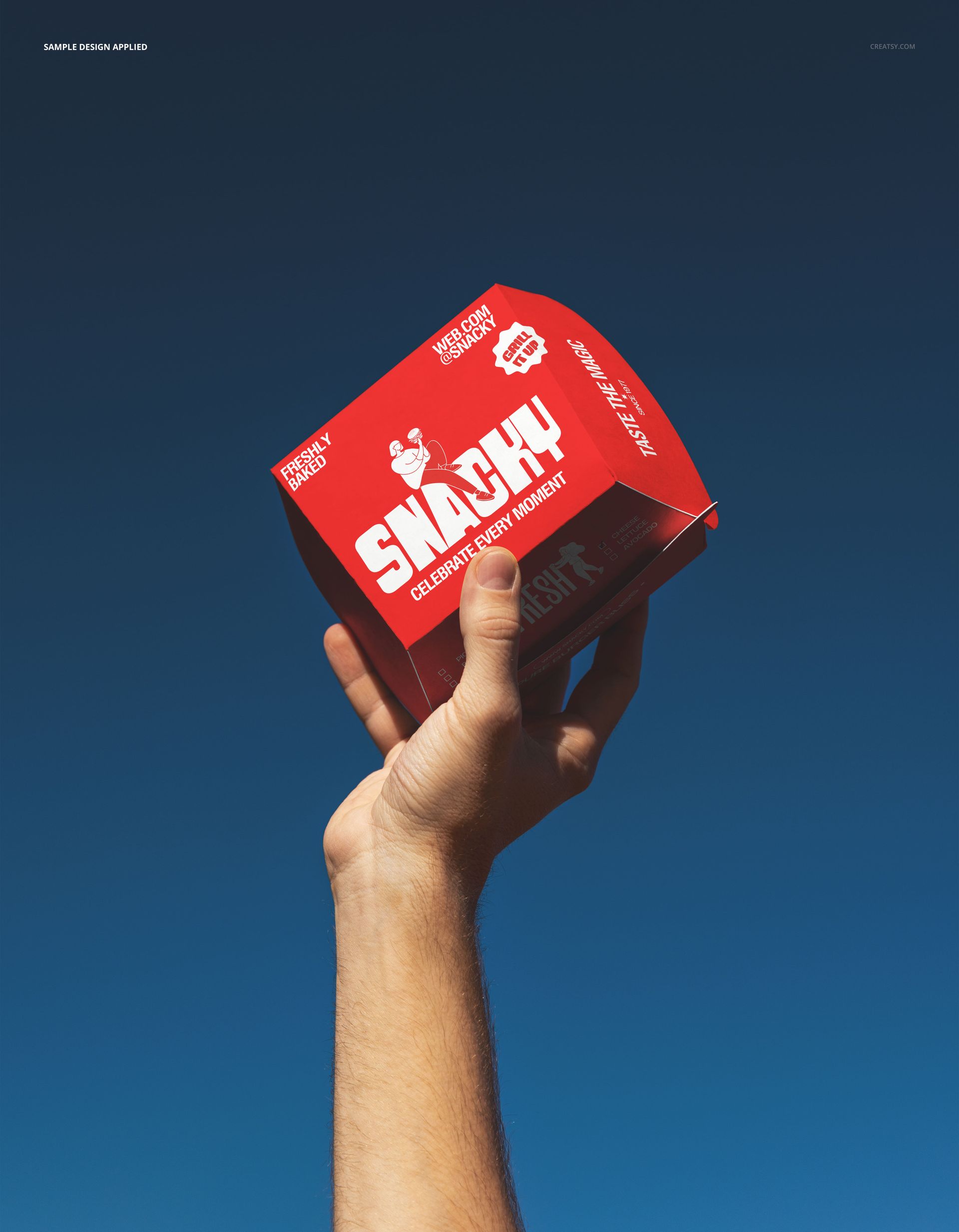 Hand holding a red burger box mockup raised against a clear blue sky, showing front and side packaging design.