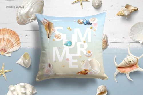 Mockup of a decorative pillow featuring a summer-themed seashell print, surrounded by assorted shells and starfish.